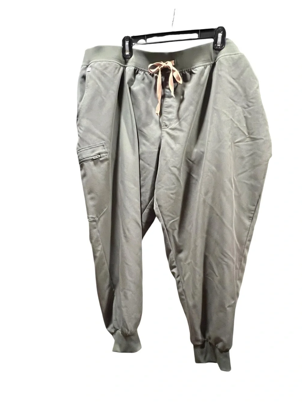 FIGS Casma three-pocket V-neck scrub top featuring a soft greyish-green.